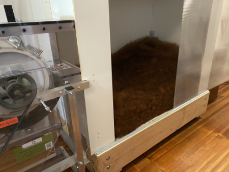 looking inside the catch bin at picked fiber