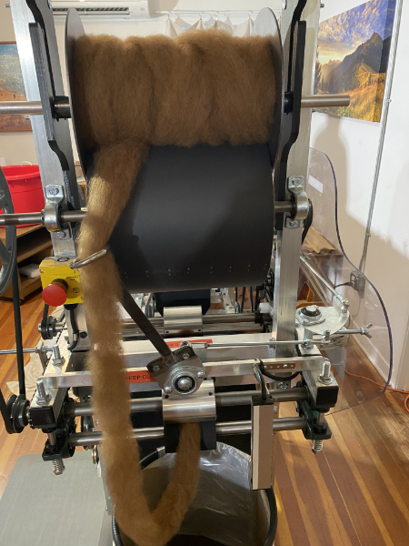 fiber exiting the carding machine as roving, being spooled into a roving bump
